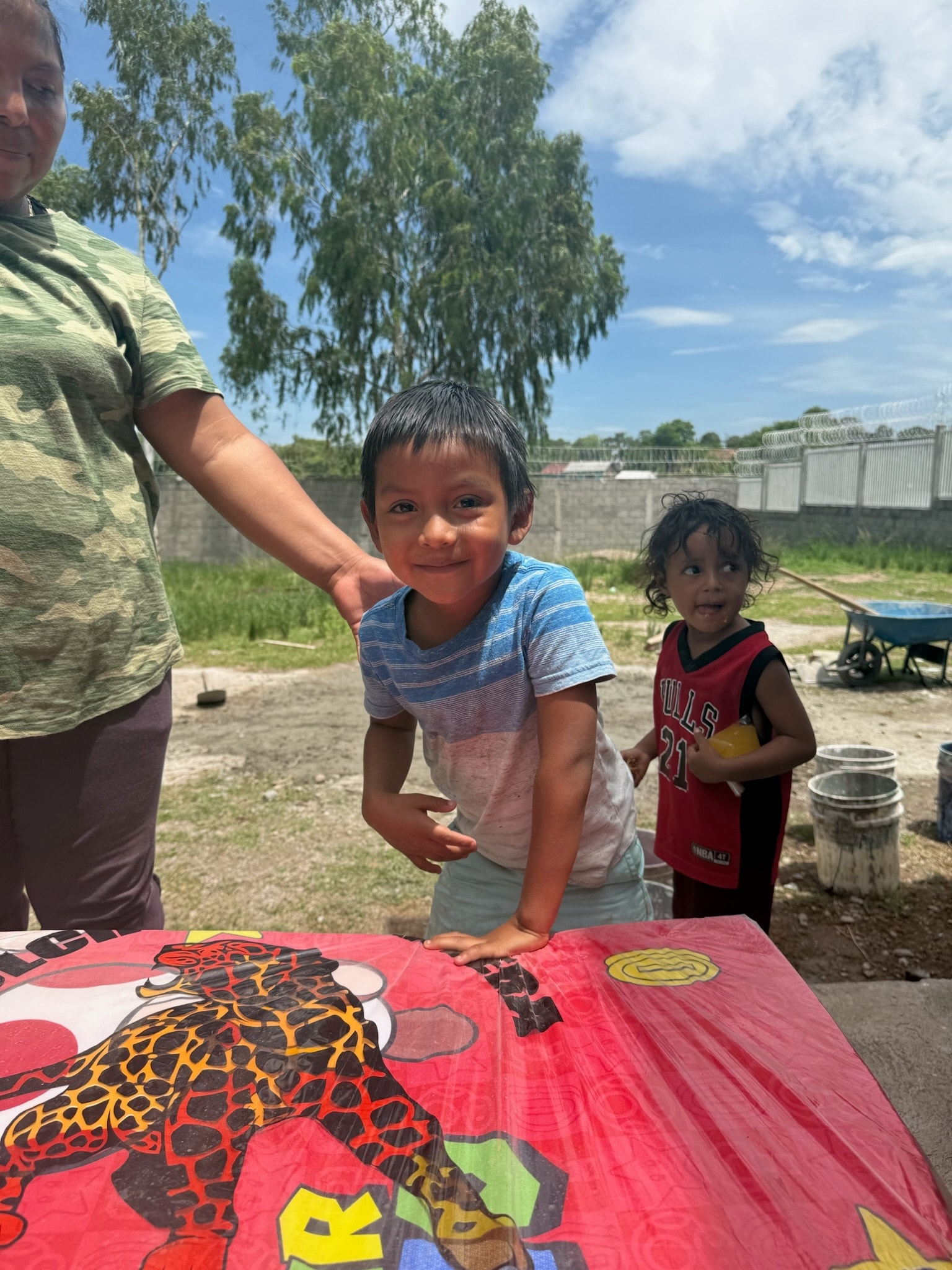 Children playing with a kite at a community gathering in Honduras