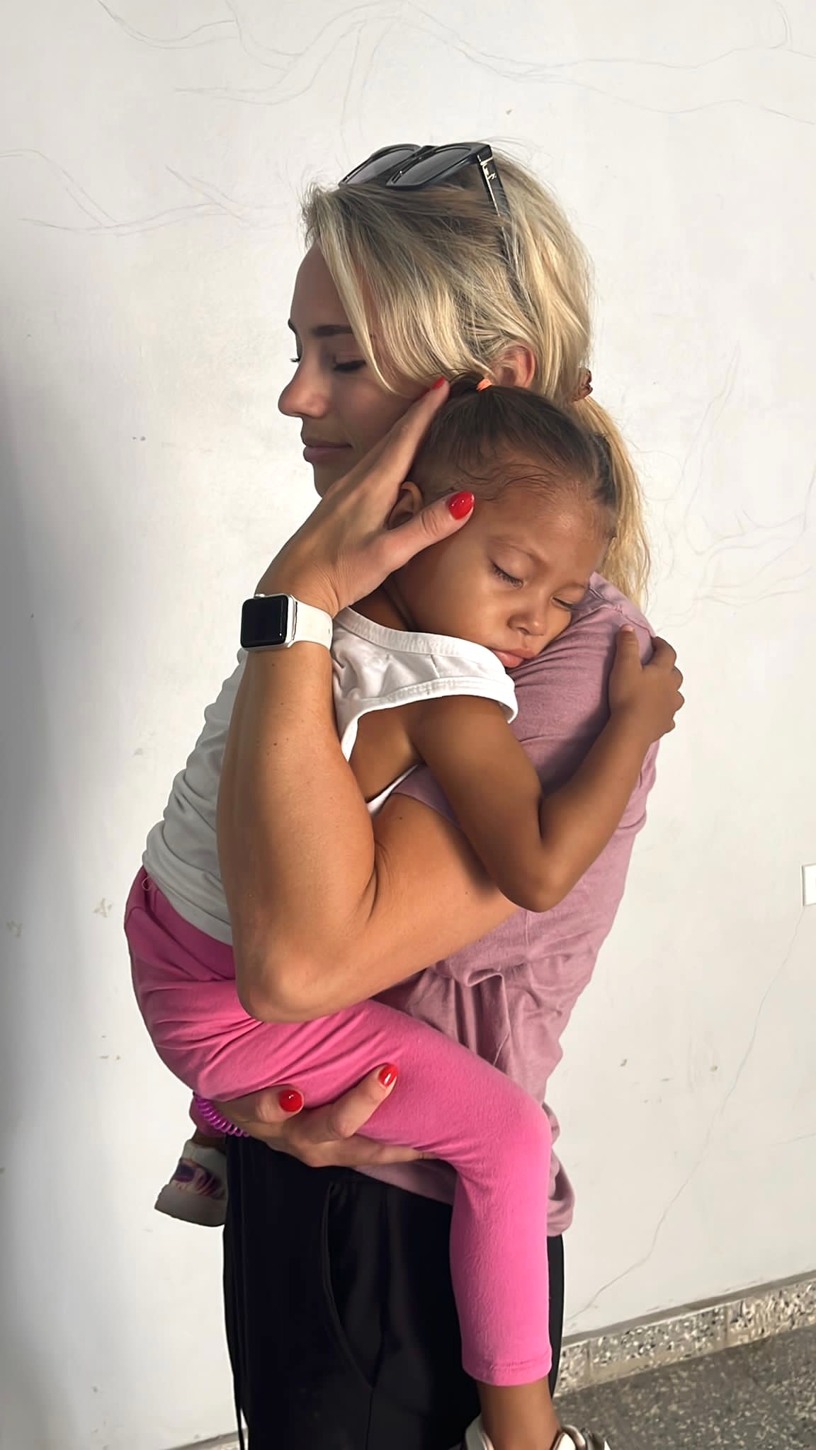 Mother holding her young daughter close