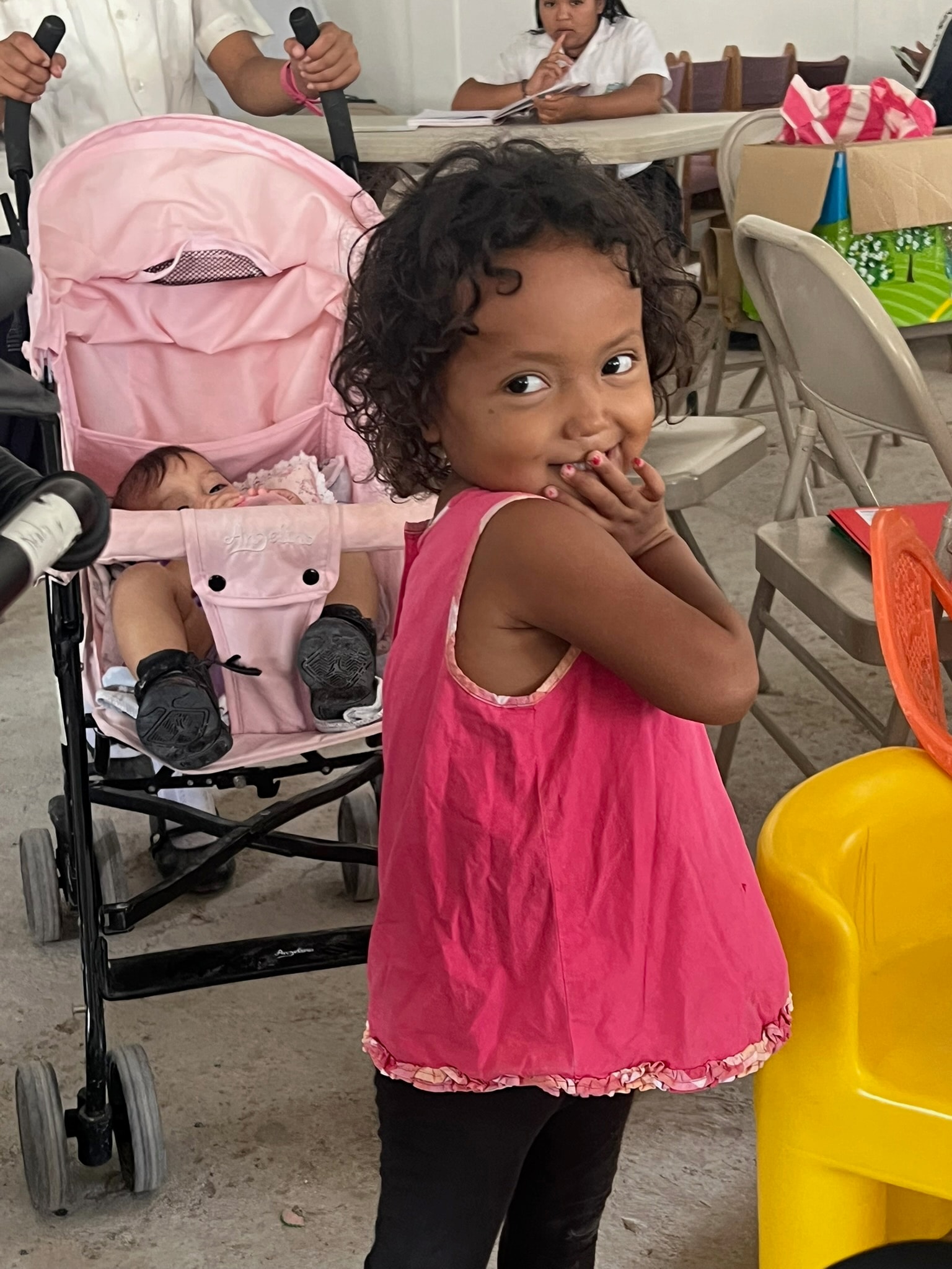 Toddler in a pink dress — a family supported by Dear Rubi