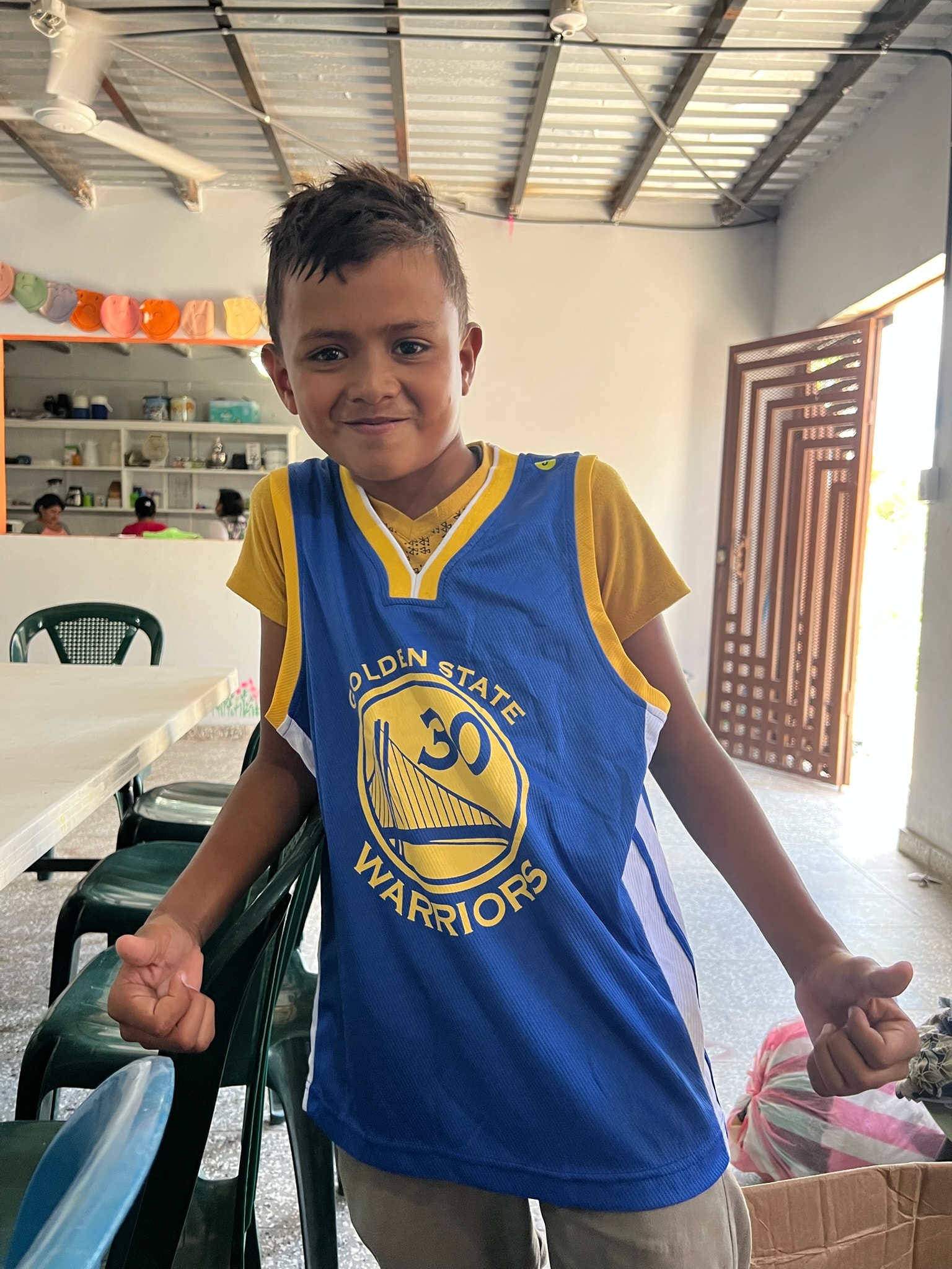 Young boy in a basketball jersey — a child in Honduras